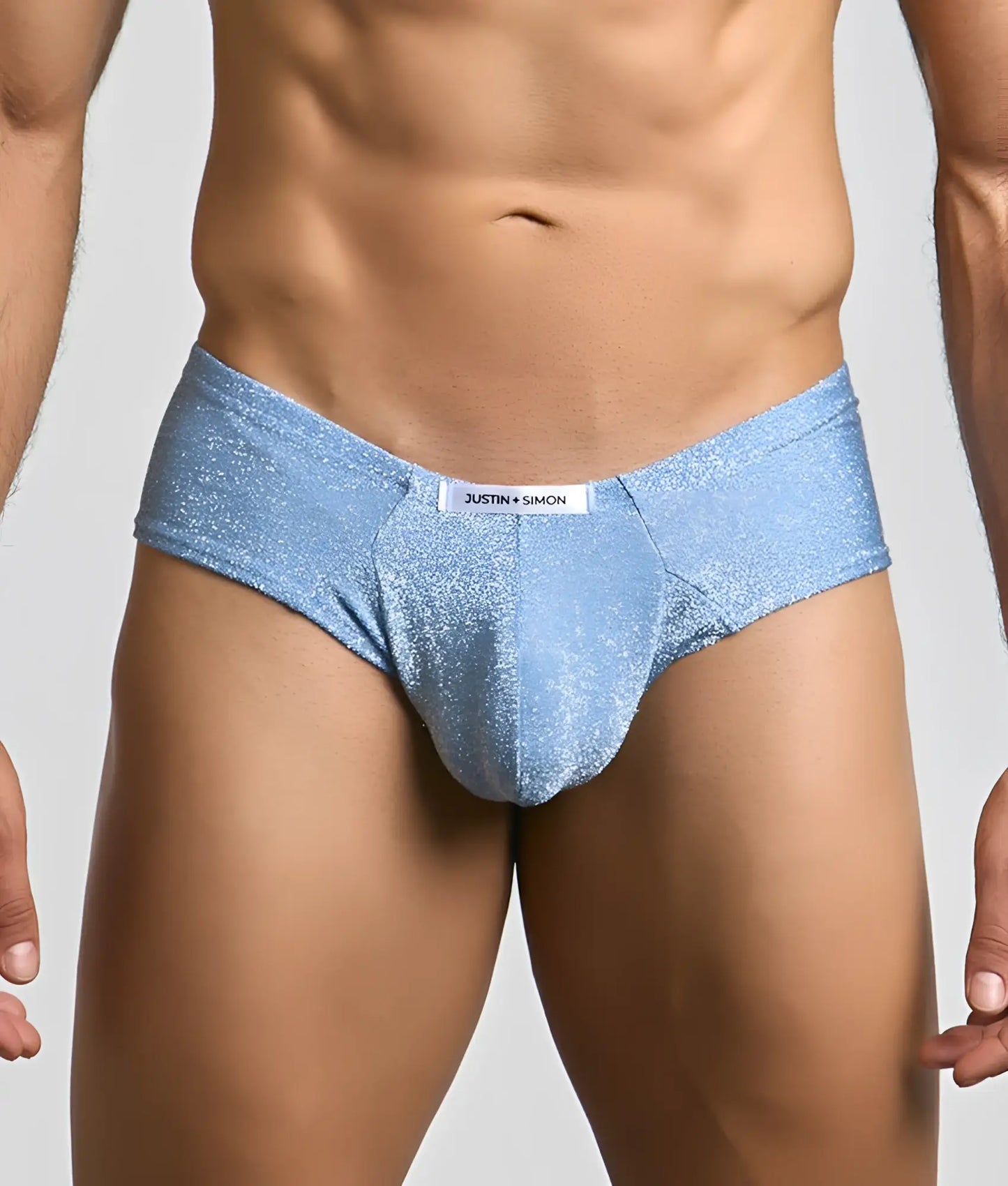 Light blue glittery fabric briefs with a white justin plus simon label on the waistband from the cheek collection