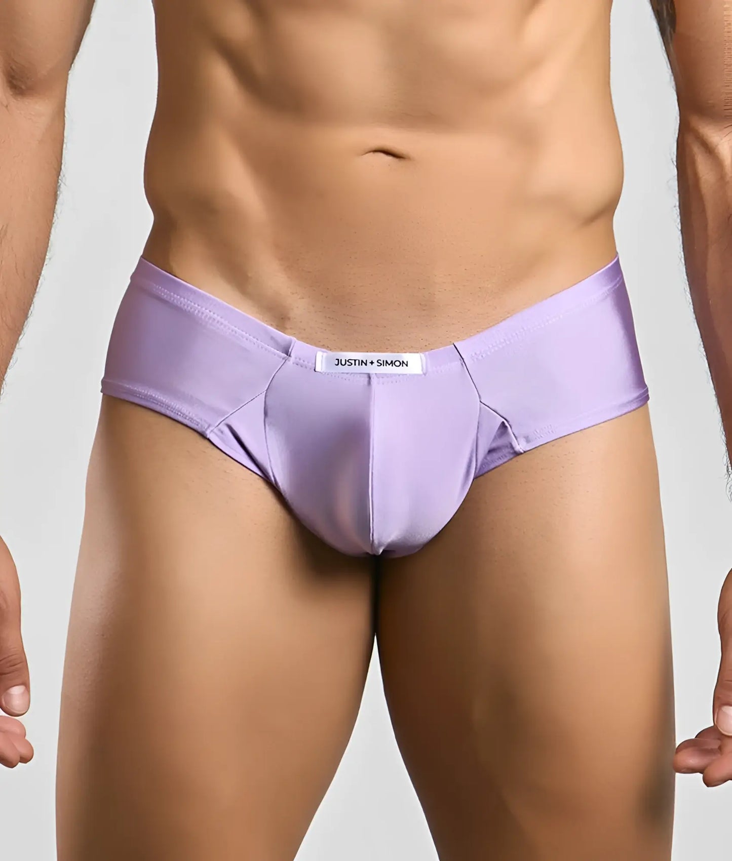 Purple justin simon cheek briefs with smooth form-fitting fabric and a white brand label at the waistband