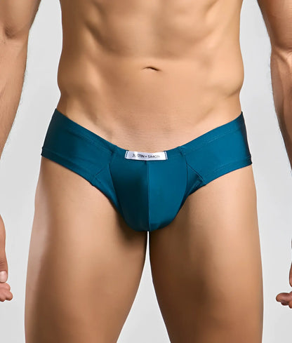 Teal-colored Justin Simon Cheek briefs with a sleek smooth fabric and a white brand tag at the waistband