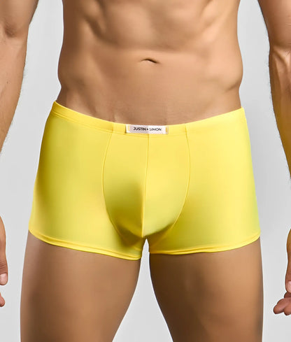 Bright yellow justin simon classic boxer briefs with smooth form-fitting fabric and white brand tag at the waistband