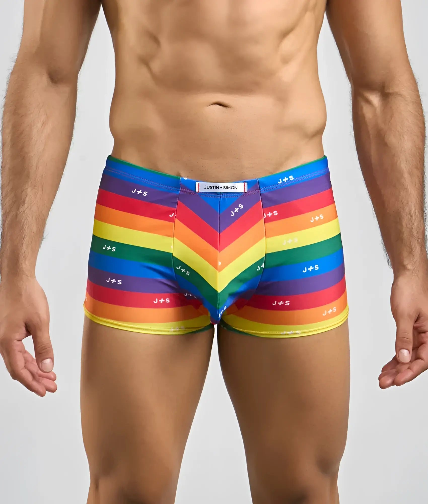 Vibrant rainbow-striped men’s boxer briefs with j+s branding chevron pattern and elastic waistband by justin + simon