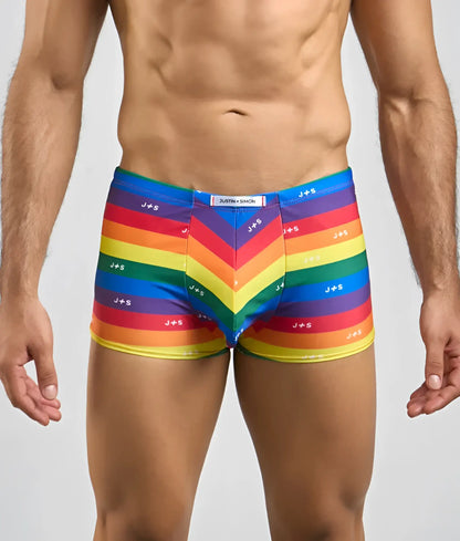 Vibrant rainbow-striped men’s boxer briefs with j+s branding chevron pattern and elastic waistband by justin + simon