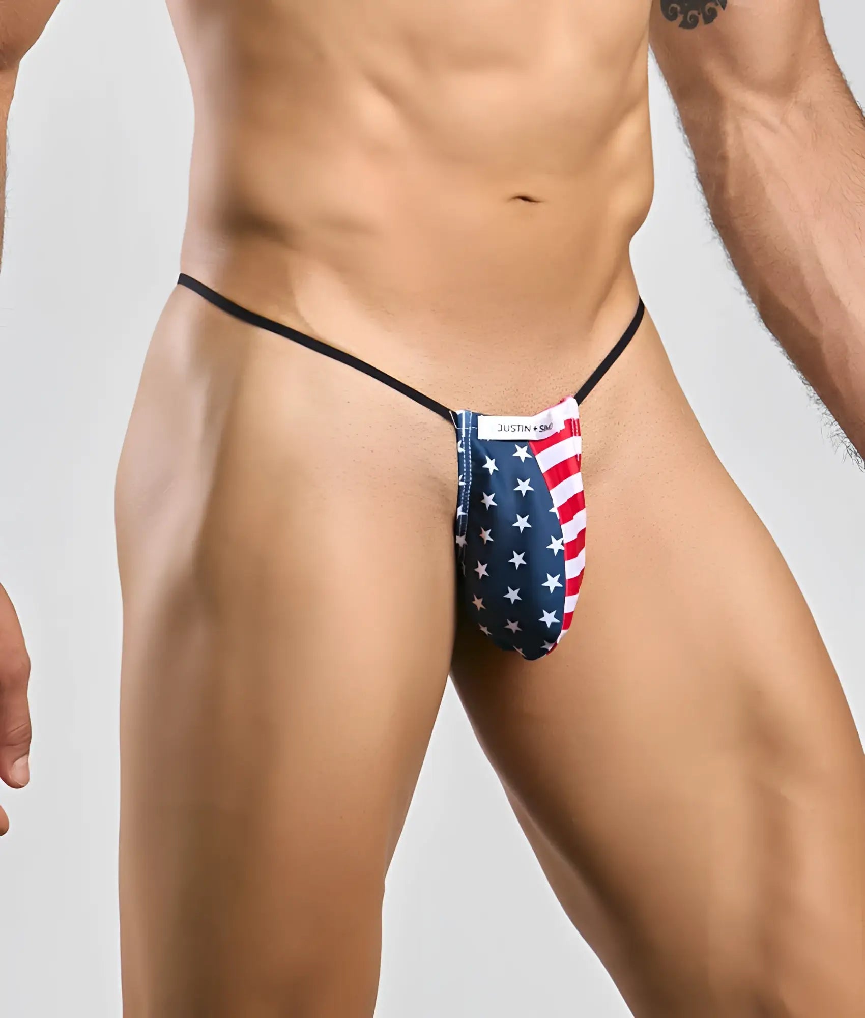 American flag patterned thong with black elastic straps and justin brand label from justin simon classic g-string bulge line