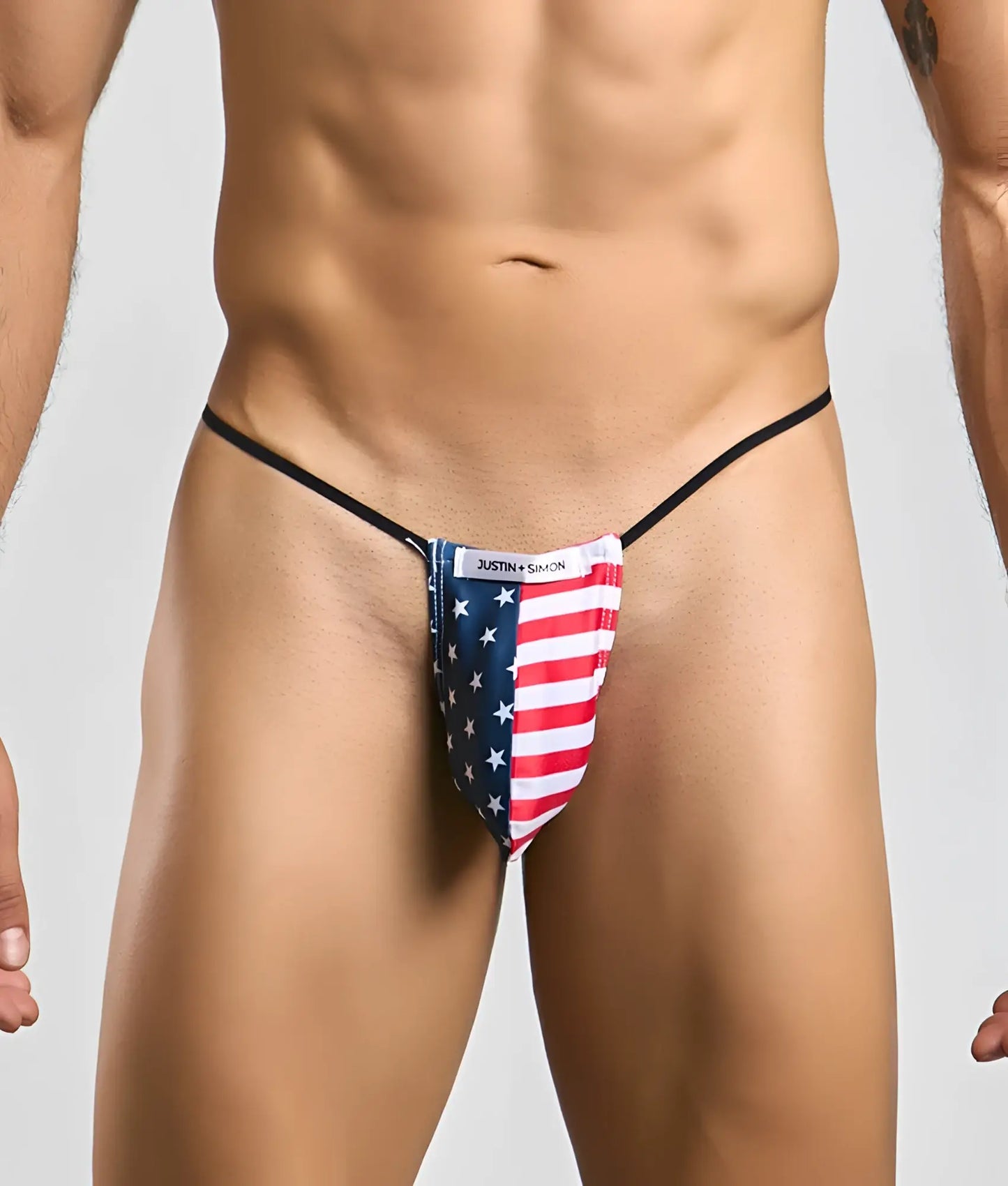 Justin simon classic g-string bulge thong featuring american flag red white stripes and blue stars on stretchy fabric