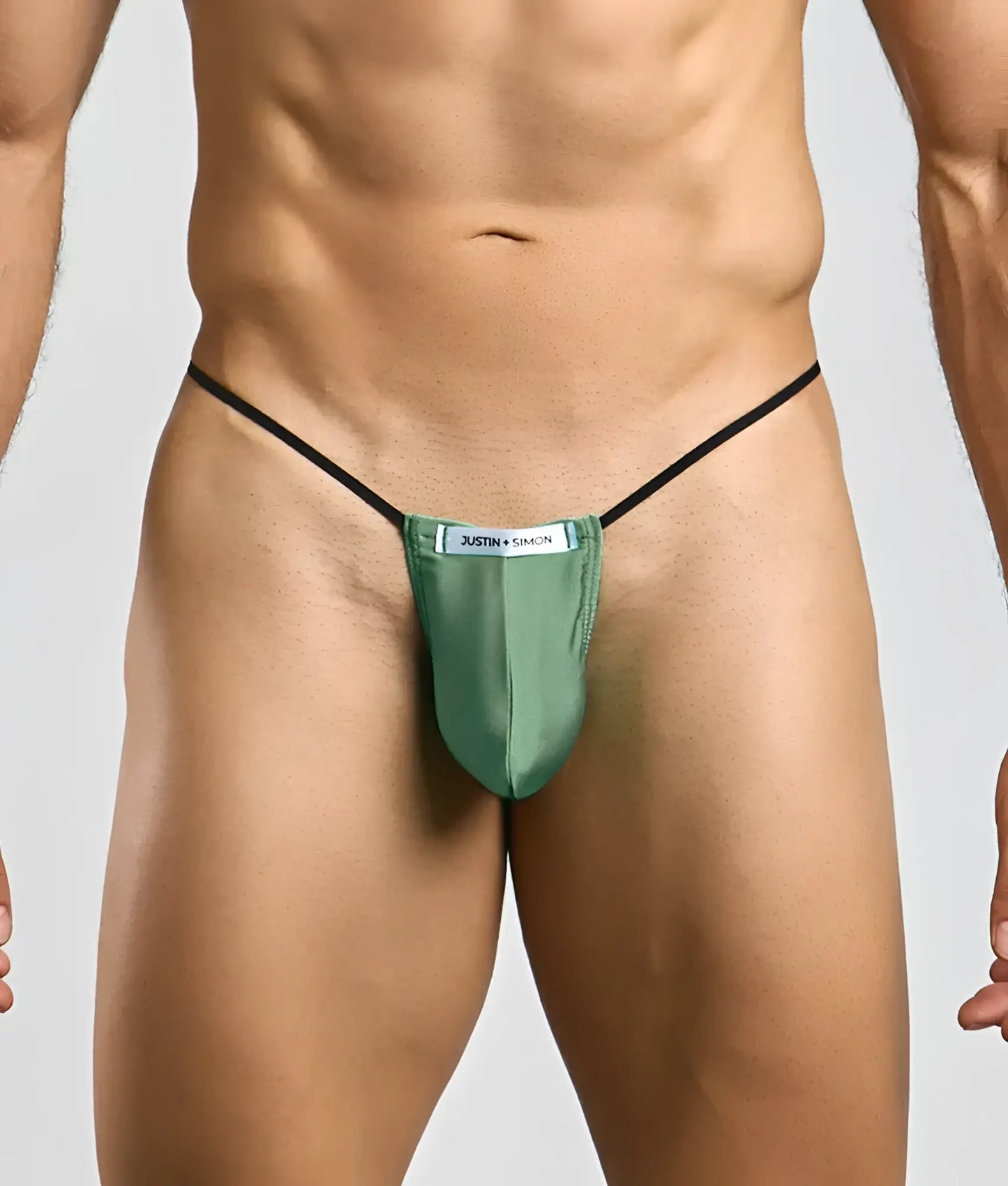 Green satin thong with black elastic straps and white justin simon label from the Justin plus Simon classic G-string bulge collection
