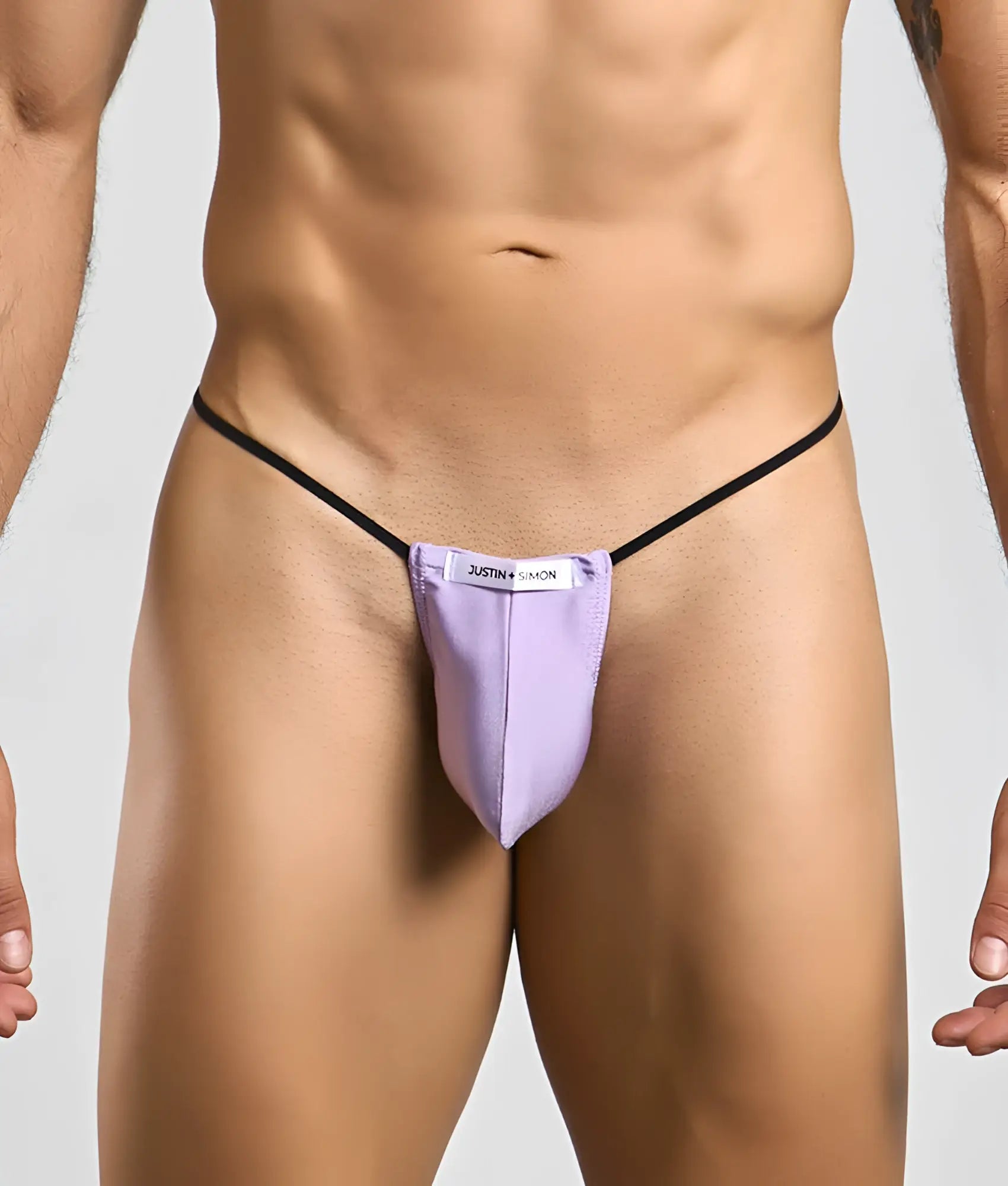 Purple justin simon classic g-string bulge thong with black elastic straps showing the back side of the product