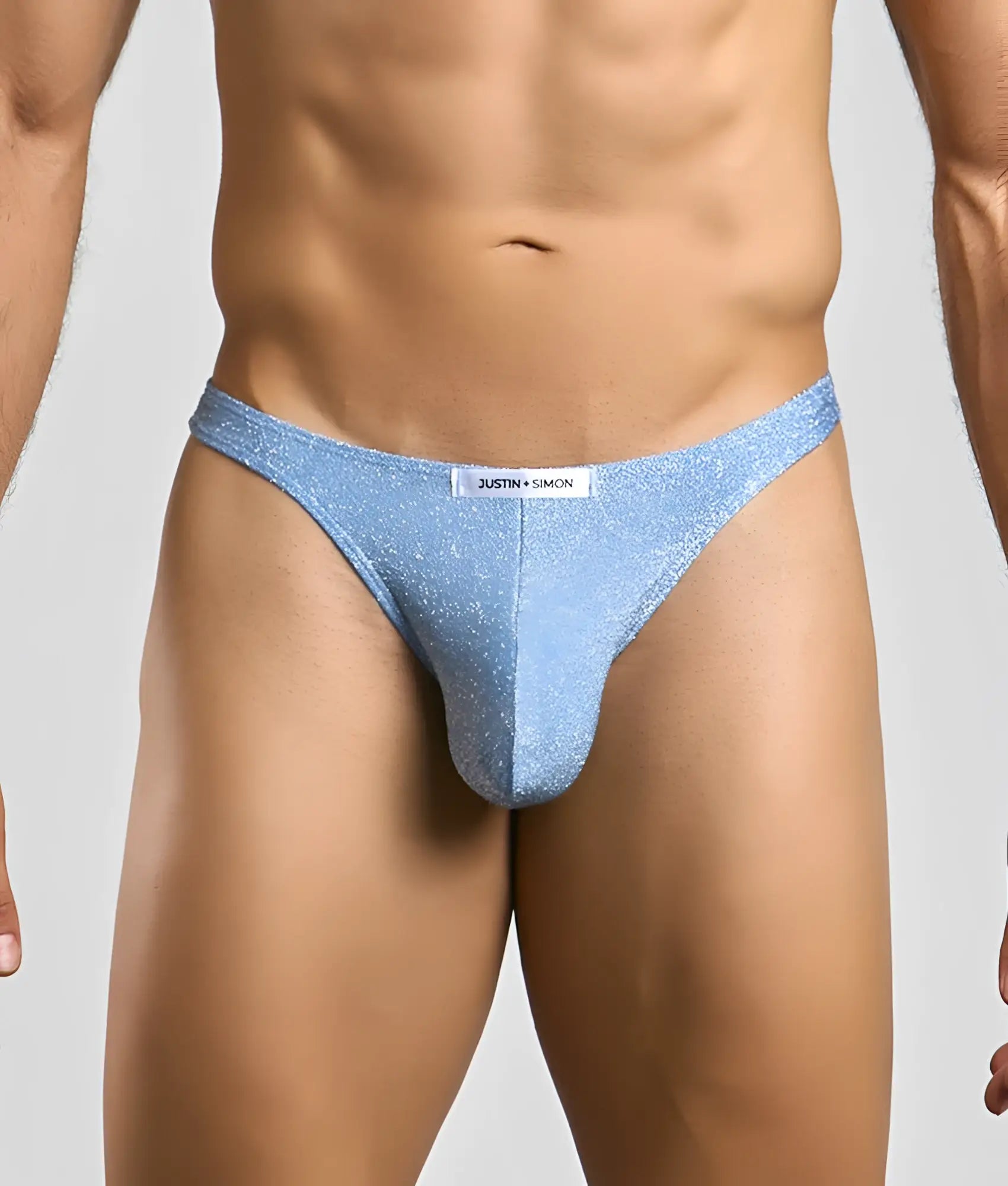 Light blue glittery thong by Justin Simon classic tanga showcasing sparkling fabric and sleek design