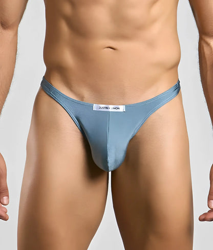 A light blue form-fitting thong with a white justin simon label at the waistband from the Justin plus Simon Classic Tanga collection