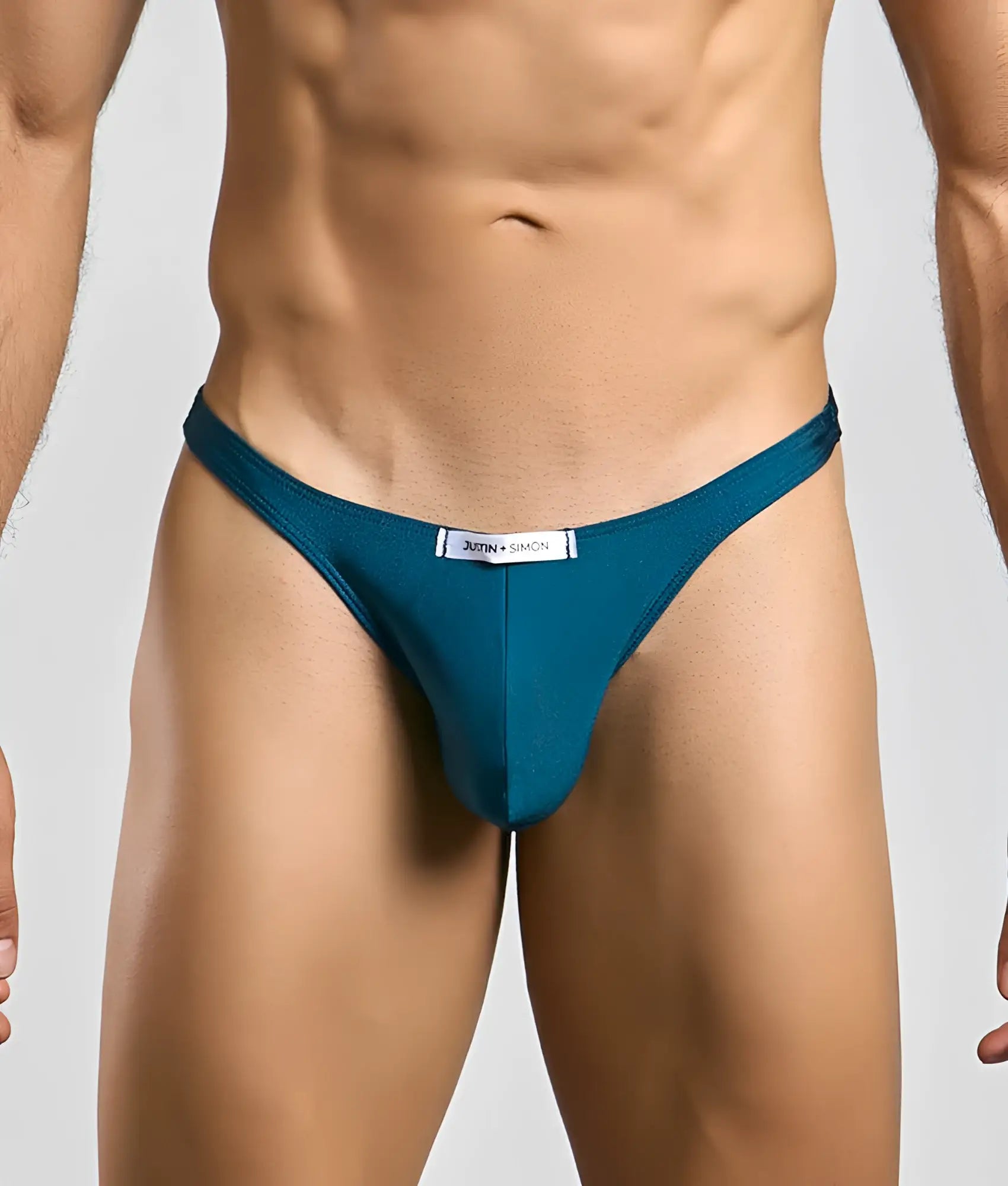 Teal-colored justin and simon classic tanga thong with a sleek form-fitting design shown from the back side