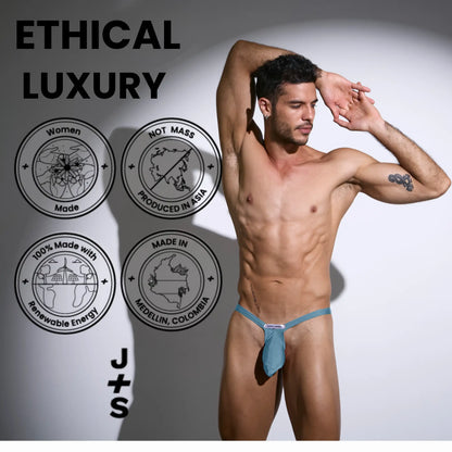 A teal men’s bulge thong mesh with form-fitting design and small brand tag at the front by Justin Simon