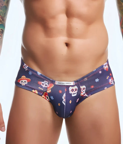 Dark blue men’s briefs with a vibrant sugar skull pattern and floral accents from justin simon cheek fun prints