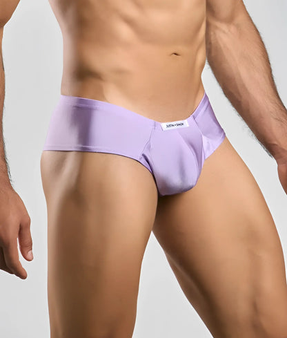Lavender-colored smooth-textured briefs with a white brand tag on the waistband from justin + simon cheek collection