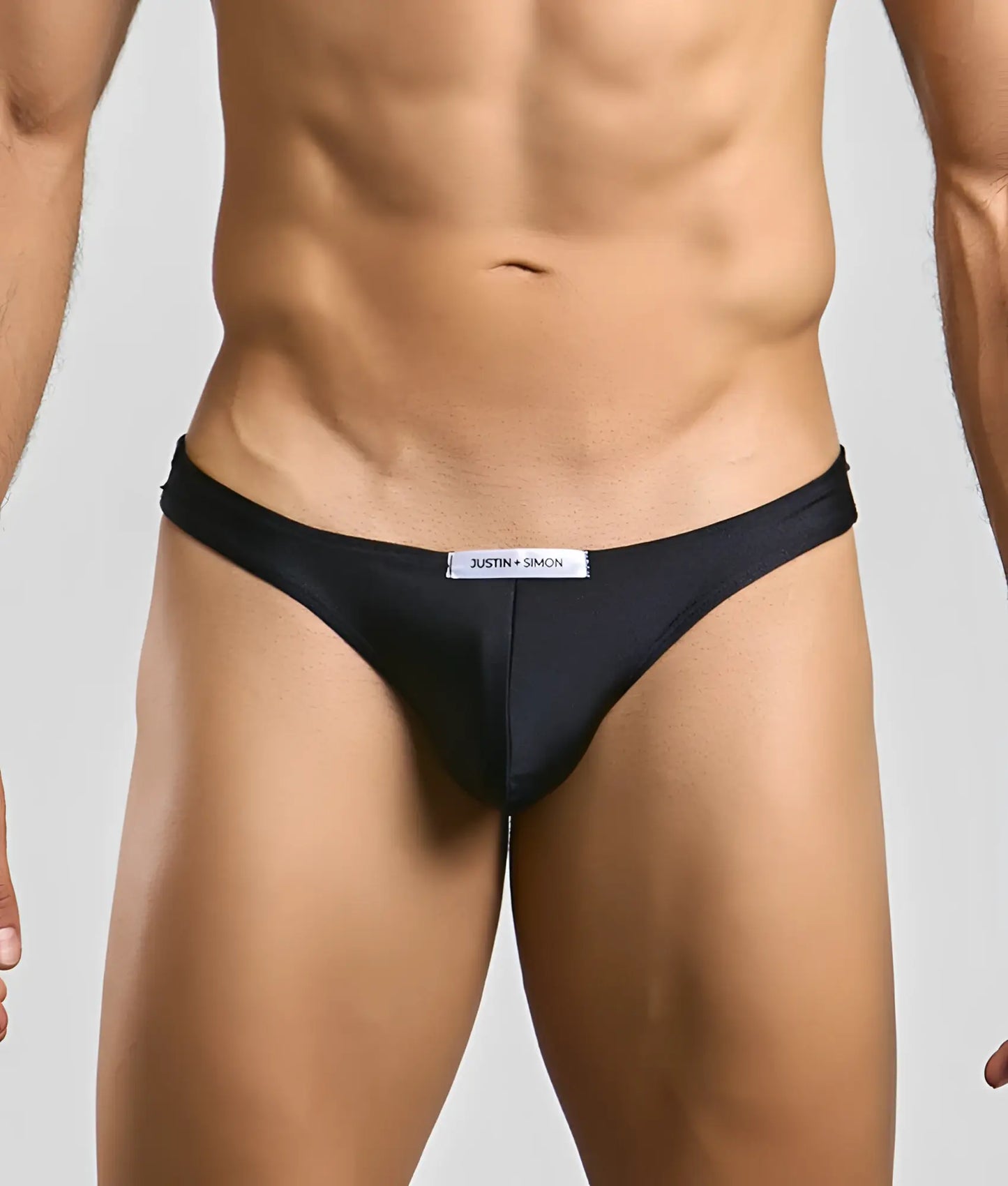 Black justin simon classic mens bikini briefs with sleek form-fitting design and subtle brand tag at the waistband