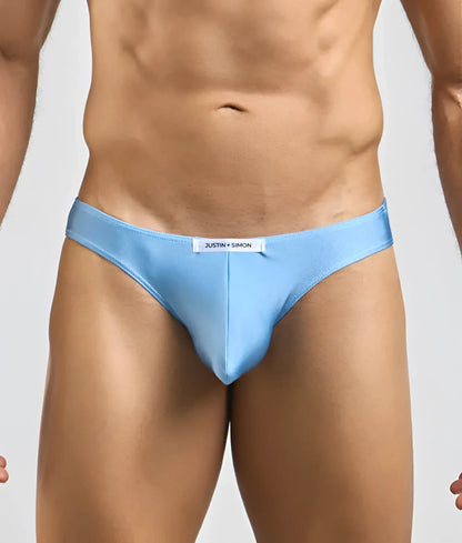 Light blue Justin Simon classic mens bikini briefs with sleek form-fitting design and subtle brand tag at waistband