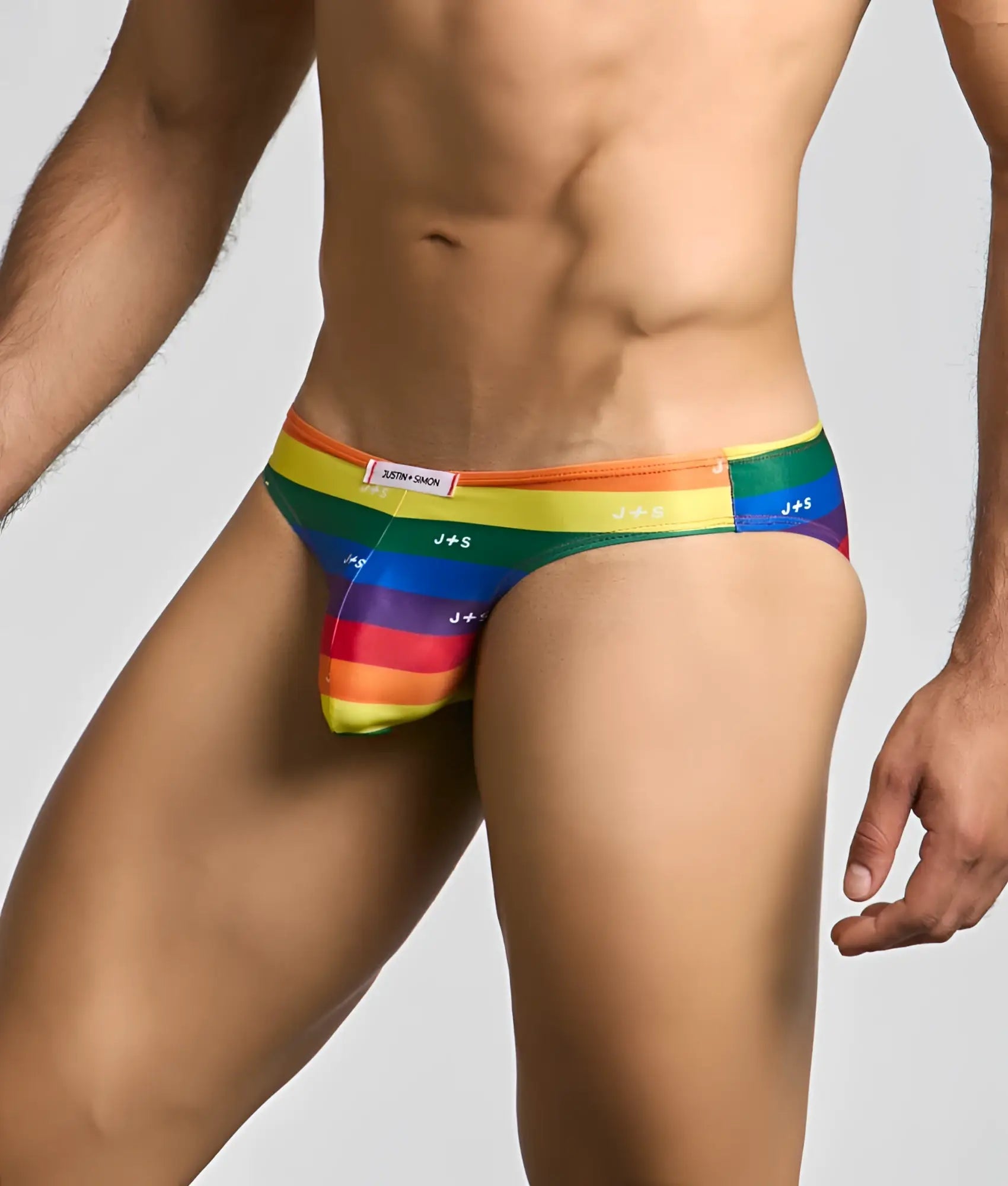 Rainbow-striped justin simon classic mens bikini briefs with j+s branding and snug form-fitting design