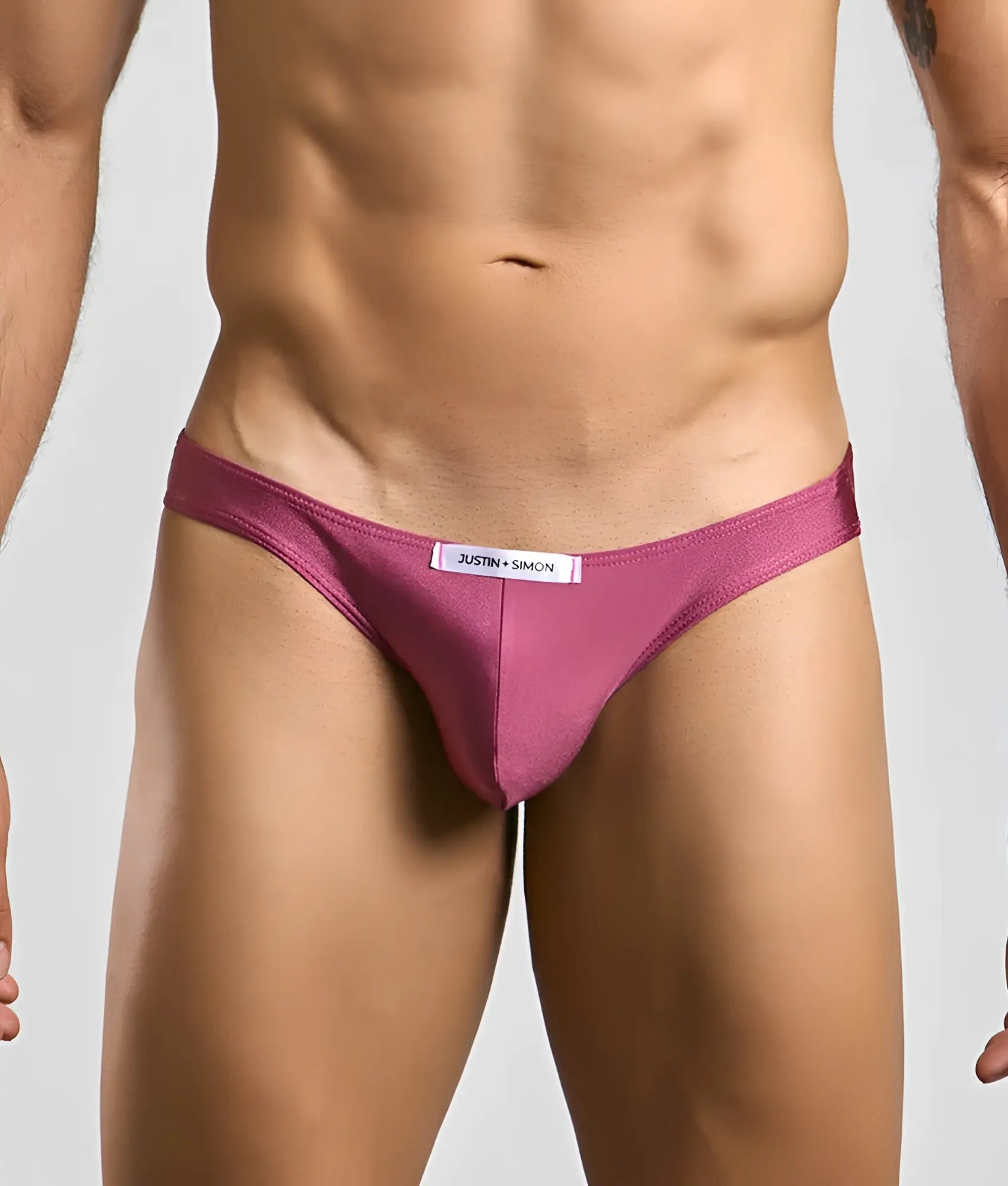 Justin simon classic mens bikini in magenta with smooth fabric finish and white waistband label visible from the front