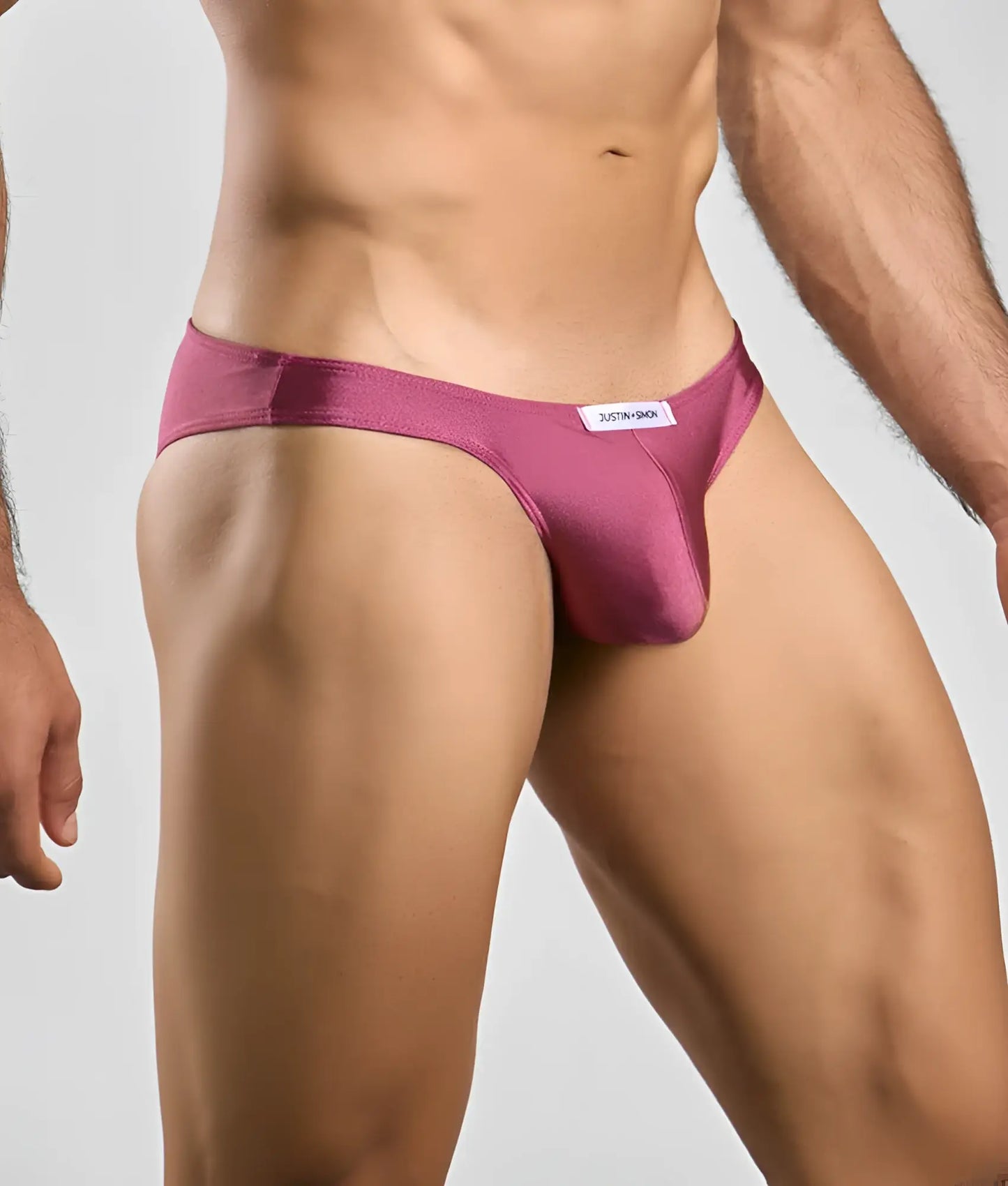 Justin + Simon classic mens bikini in sleek magenta satin with minimalist design and white brand tag at waistband