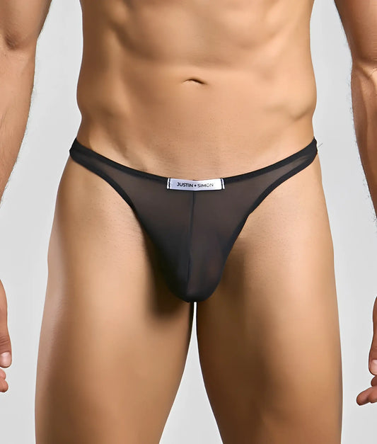 Black sheer mesh thong with a white justin simon label at the waistband from the classic tanga mesh collection