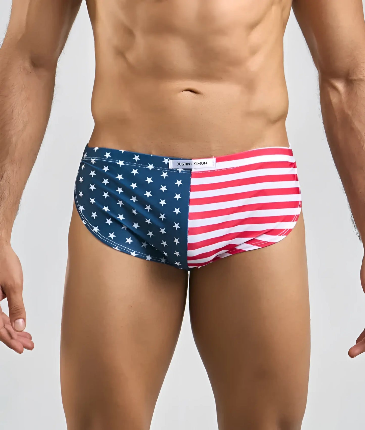Justin + Simon running short American flag themed men’s briefs in red white and blue with star and stripe design