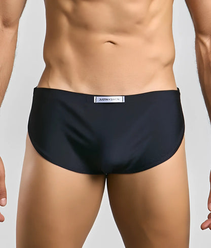 Black justin simon running short briefs with subtle textured fabric and white label at waistband