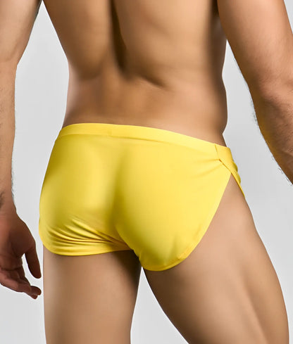 Bright yellow justin + simon running shorts with sleek smooth fabric and distinctive side slit for active wear