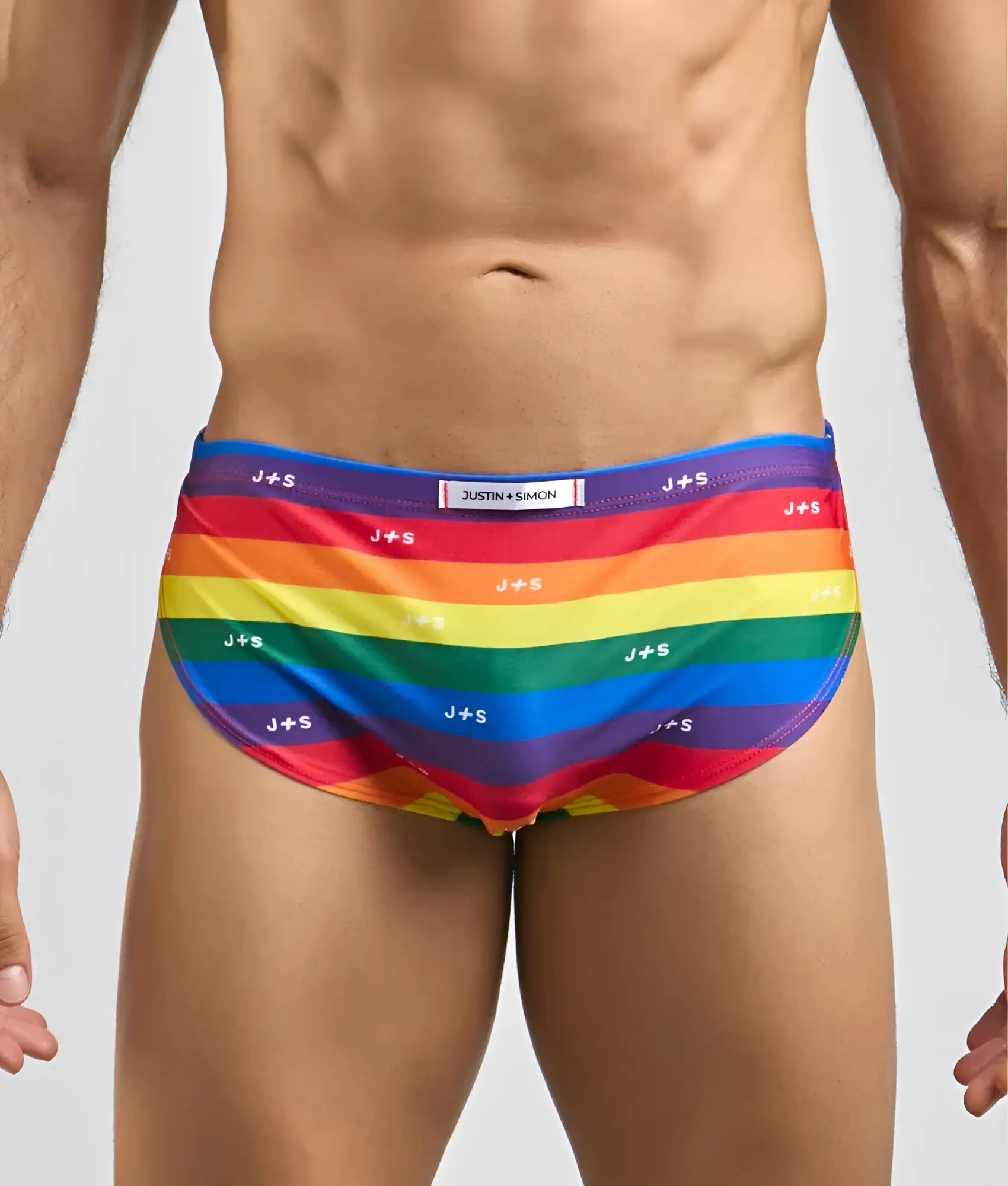 Rainbow-striped men’s running swim trunks by justin simon with vibrant colors and repeating js branding