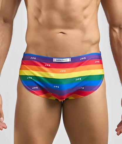 Rainbow-striped men’s running swim trunks by justin simon with vibrant colors and repeating js branding