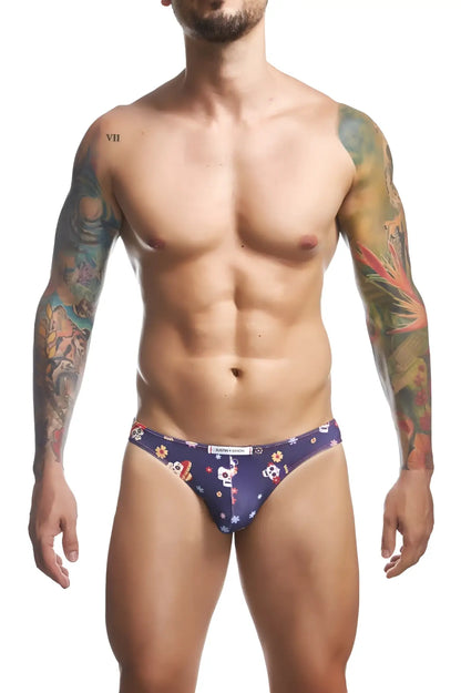 Dark blue men’s classic bikini briefs by justin simon xsj01 with white skulls orange and yellow flowers and stars pattern