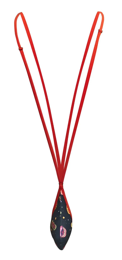 A vibrant red corded necklace with a teardrop navy fabric pendant featuring colorful paisley and star patterns by justin simon