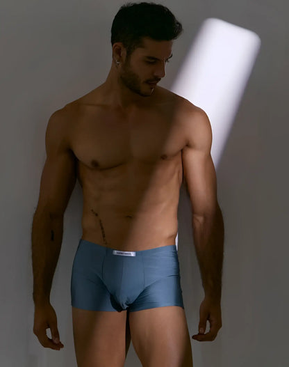 Blue cotton boxer briefs with a white brand label at the waistband from justin simon xsj08 classic metal green collection