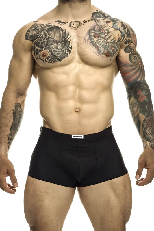 Black justin simon classic trunks with white brand label on waistband made of soft breathable fabric