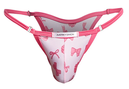 Pink bow-patterned thong bikini by justin + simon in coquette color perfect for stylish swimwear looks