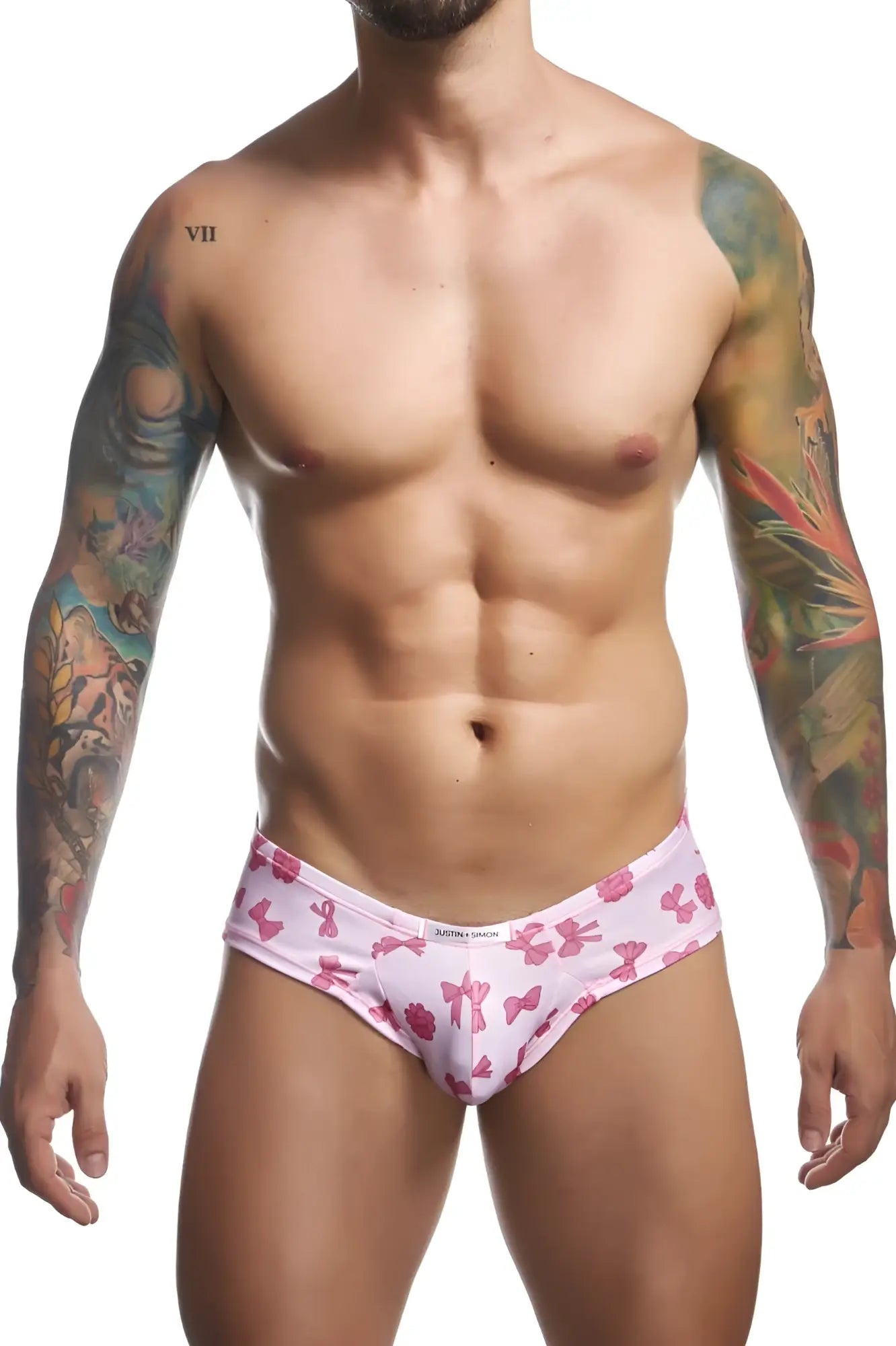 Pink bow-patterned mens briefs with white waistband and xterra touch branding from justin simon cheek briefs color coquette