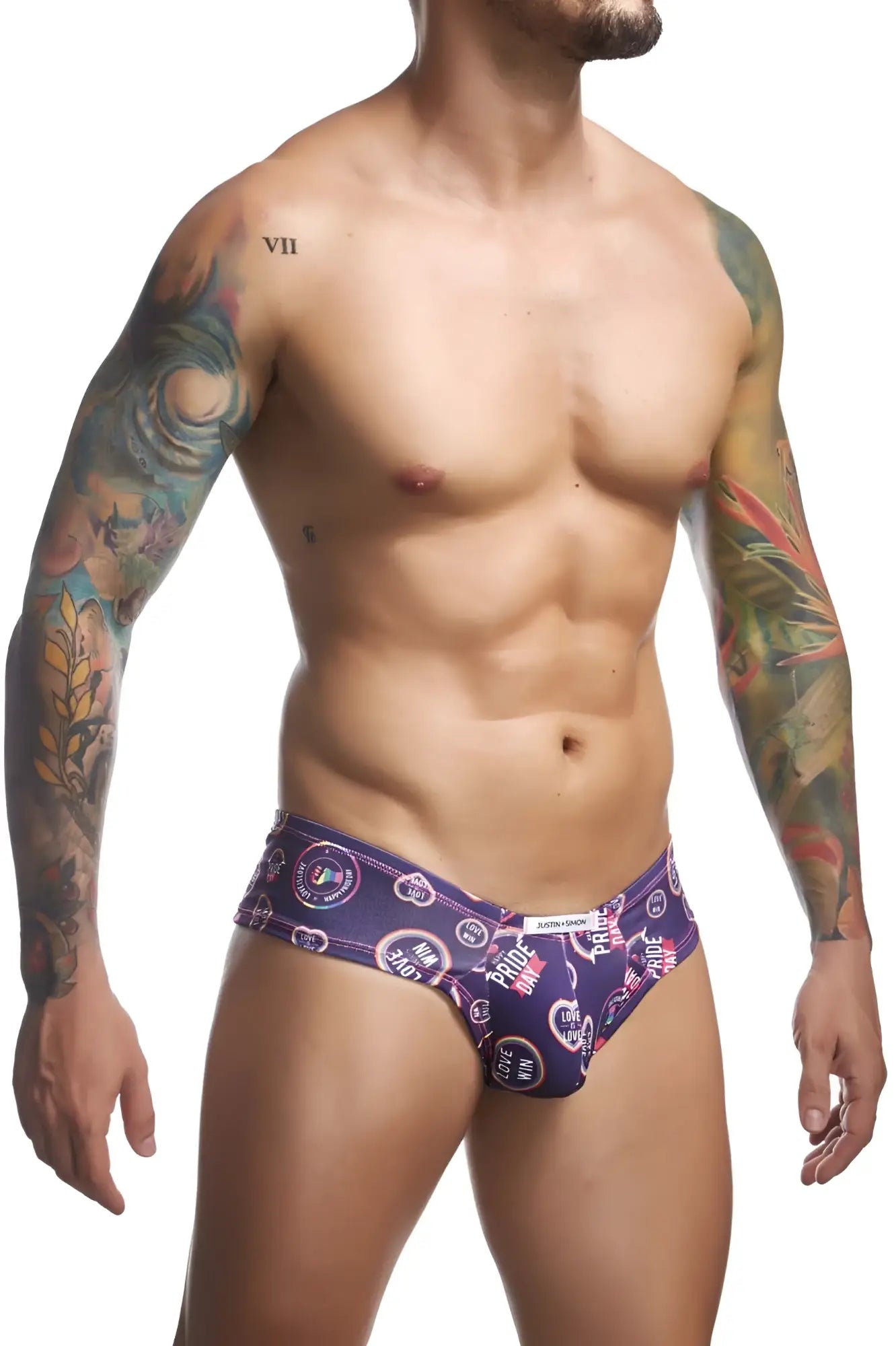 Purple patterned men’s briefs by justin simon with circular pride motifs and heart symbols in a vibrant cheek brief design