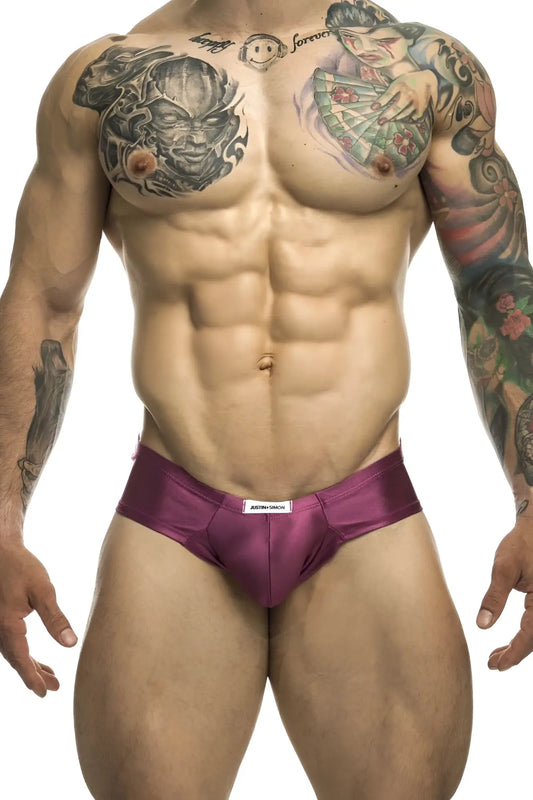 Purple satin cheek briefs with a white brand tag at the waistband from justin simon xsj22 wine color