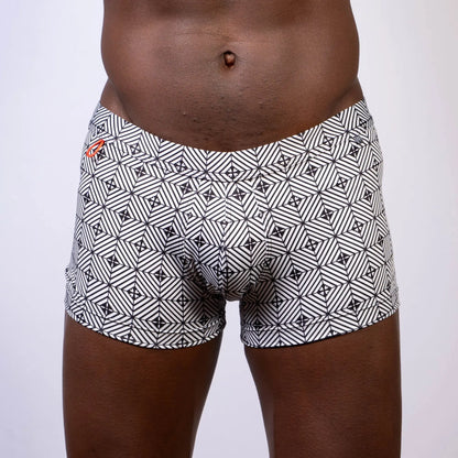 Black and white geometric patterned kaleidoscope sq cut trunk boxer briefs with subtle orange logo on waistband