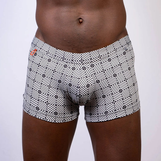 Black and white geometric patterned kaleidoscope sq cut trunk boxer briefs with subtle orange logo on waistband
