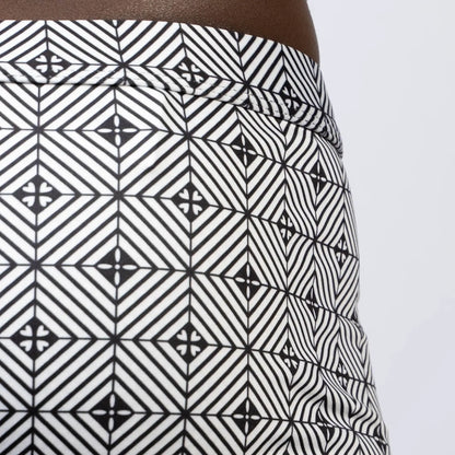 Black and white geometric-patterned kaleidoscope sq cut trunk skirt with bold repeating diamond design
