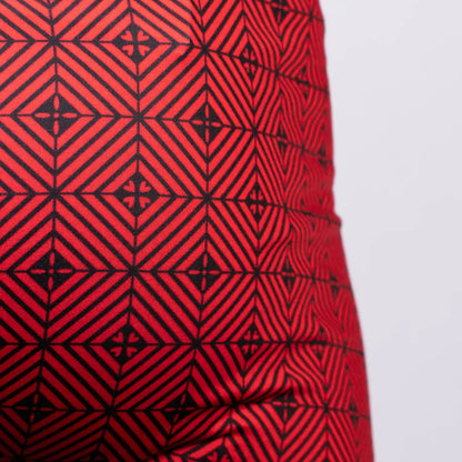Red fabric of the Kaleidoscope sq cut trunk with a bold black geometric pattern of interlocking diamonds and cross motifs