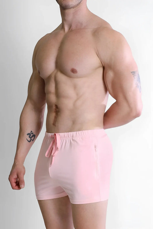 Pink athletic shorts with drawstring waistband and side zipper pocket designed for activewear in baby pink color