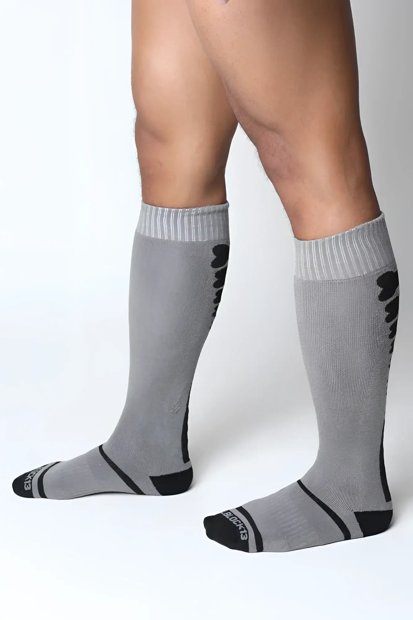 Kennel club bones knee high socks in gray with black accents ribbed cuffs and a subtle textured pattern