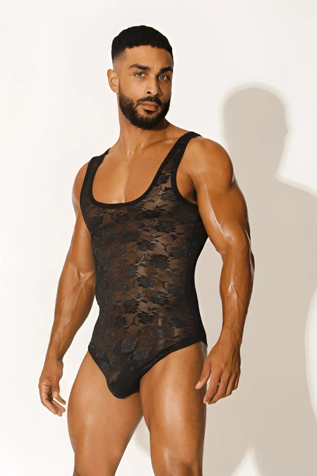Black lace kiss-it-better bodysuit with floral pattern featuring sheer delicate fabric and elegant design