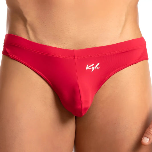 Red menâ€™s swimming thong trunks with white kyla logo embroidered on the front for beachwear use