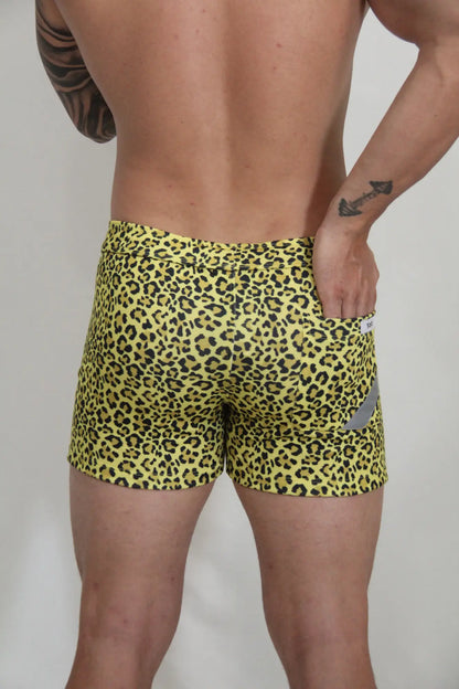Yellow leopard fleece short with snug fit swim trunks and small gray reflective patch on the side