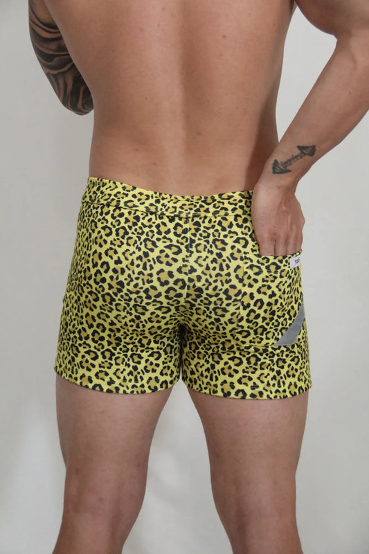 Yellow leopard fleece short with snug fit swim trunks and small gray reflective patch on the side