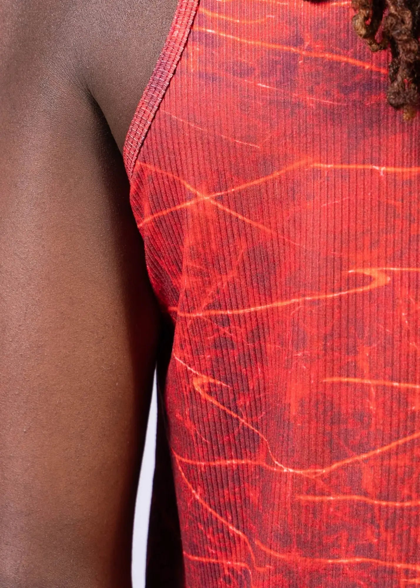 Red ribbed lightning print tank top with marbled crackled pattern in shades of orange and dark red