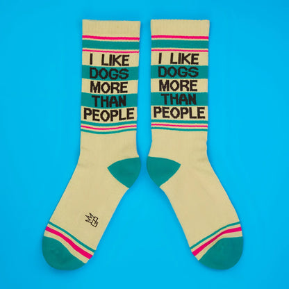 Cream-colored crew socks with teal and pink stripes featuring black text i like dogs more than people for casual wear
