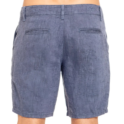 Blue linen slim fit shorts in denim with textured weave and two back pockets shown from the back side
