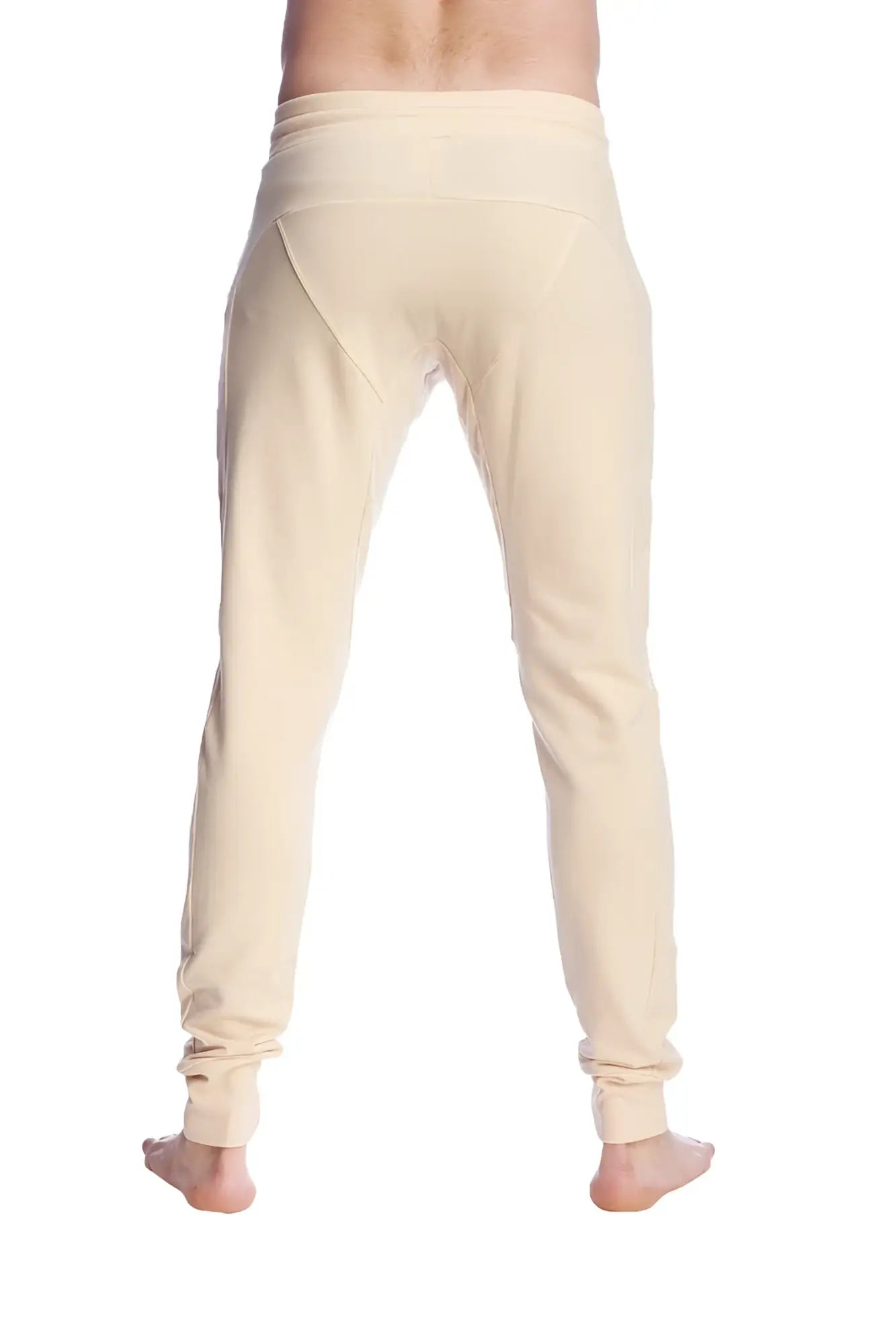 Cream-colored stretchy long cuffed jogger and yoga sweat pants in sand beige with tapered fit and rolled cuffs