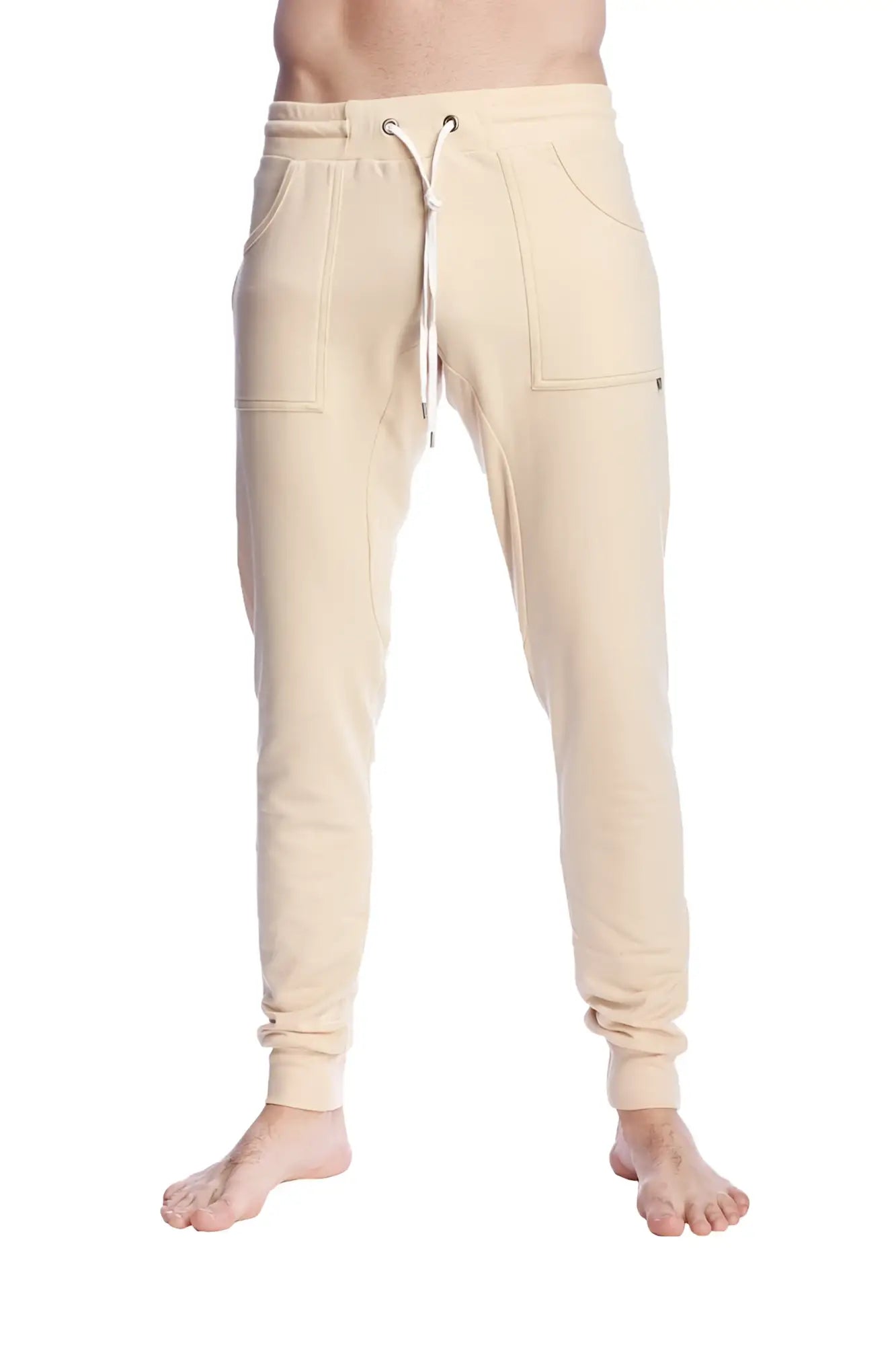 Cream-colored long cuffed jogger and yoga sweat pants in sand beige with drawstring waist and side pockets